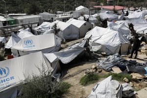 A migrant walks at the Moria refugee camp on the northeastern Greek island of Lesbos, Thursday, March 16, 2017.