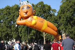 People watch as an inflatable caricature balloon of Mayor of London, Sadiq Khan is released over Parliament Square in London, Saturday, Sept. 1, 2018