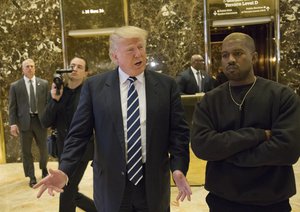 File - President-elect Donald Trump, left, and Kanye West pose for a picture in the lobby of Trump Tower in New York, Tuesday, Dec. 13, 2016.