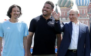 Vladimir Putin with former members of the Russian national football team Alexei Smertin and former Brazil player Ronaldo before a friendly match between world football stars and young players from FC Totem Krasnoyarsk