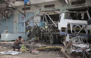 File - A man inspects the wreckage of a bus at the site of a deadly Saudi-led coalition airstrike on Thursday, in Saada, Yemen, Sunday, Aug. 12, 2018.