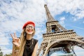 Woman tourist posing at Eiffel Tower.