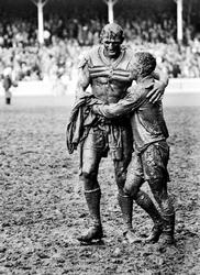 GLADIATORS: Norm Provan and Arthur Summons embrace