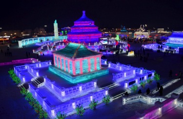 Visitors walk among the attractions at the Harbin International Ice and Snow Festival in Harbin in northeastern China's ...