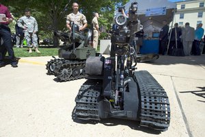 File - Marine Corps Gunnery Sgt. Joseph Perara guides a robot during the Department of Defense Lab Day at the Pentagon, May 14, 2015. Perara is assigned to the Marine Warfighting Laboratory.