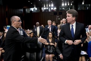 Fred Guttenberg, the father of Jamie Guttenberg who was killed in the Stoneman Douglas High School shooting in Parkland, Fla., left, attempts to shake hands with President Donald Trump's Supreme Court nominee, Brett Kavanaugh, right, as he leaves for a lunch break while appearing before the Senate Judiciary Committee on Capitol Hill in Washington, Tuesday, Sept. 4, 2018, to begin his confirmation to replace retired Justice Anthony Kennedy.