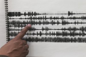 In this July 23, 2013 photo, Gilberto Castelan, director of instrumentation at Mexico’s National Disaster Prevention Center laboratory, shows a seismic graph from Dec. 18, 2000 when a large eruption was recorded at the Popocatepetl volcano in Mexico City.