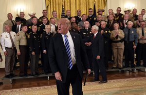 President Donald Trump responds to a reporters question during an event with sheriffs in the East Room of the White House in Washington, Wednesday, Sept. 5, 2018.