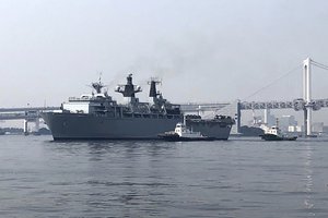 British Royal Navy's HMS Albion amphibious assault ship arrives with a city's landmark Rainbow Bridge as background in Tokyo Friday, Aug. 3, 2018. (AP Photo/Kaori Hitomi)