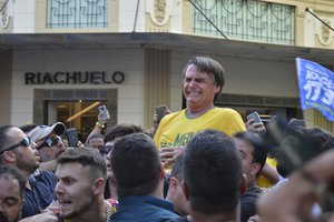 Presidential candidate Jair Bolsonaro grimaces right after being stabbed in the stomach during a campaign rally in Juiz de Fora, Brazil, Thursday, Sept. 6, 2018.