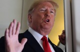 President Donald Trump talks to reporters while in flight from Billings, Montana, to Fargo, North Dakota.