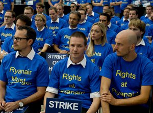 Ryanair pilots wear all the same shirt as they take part in a meeting during a strike for higher wages In Frankfurt, Germany, Friday, Aug.10, 2018.