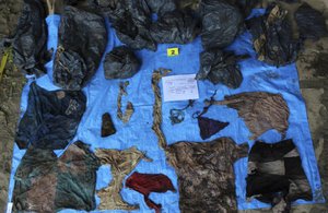 In this undated photo provided by the Veracruz State Prosecutor's Office shows clothing items found at the site of a clandestine burial pit in the Gulf coast state of Veracruz, Mexico.