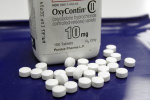 This Feb. 19, 2013 file photo shows OxyContin pills arranged for a photo at a pharmacy in Montpelier, Vt. Opening statements are scheduled Monday afternoon, Sept. 18, 2017, in a lawsuit by the city of Everett, Wash., against the makers of the prescription opioid OxyContin