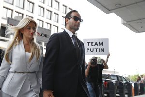 Former Donald Trump presidential campaign foreign policy adviser George Papadopoulos, who triggered the Russia investigation, and who pleaded guilty to one count of making false statements to the FBI, holds hands with his wife Simona Mangiante as they arrive at federal court for sentencing, Friday, Sept. 7, 2018, in Washington.