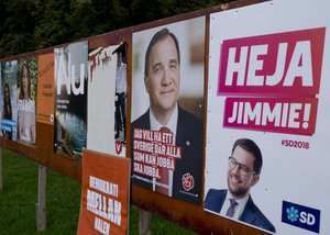 The Aug. 30, 2018 phot shows election poster of Jimmie Akesson,right, leader of the far-right Sweden Democrats and Social Democratic Prime Minister Stefan Lofven, second from right. in Flen, some 100 km west of Stockholm, Sweden. Sweden's 7.3 million voters go to polls on Sept. 9, 2018 to elect a new parliament and government.