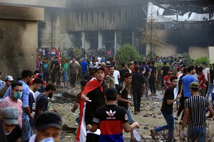 Protesters storm and burn the Basra Government building during a demonstration demanding better public services and jobs in Basra, 340 miles (550 km) southeast of Baghdad, Iraq, Friday, Sept. 7, 2018.