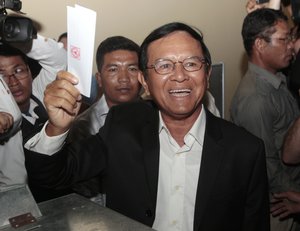 Opposition Cambodia National Rescue Party President Kem Sokha shows off his ballot before voting in local elections in Chak Angre Leu on the outskirts of Phnom Penh, Cambodia, Sunday, June 4, 2017.