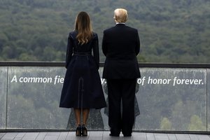 President Donald Trump and first lady Melania Trump, stand along the September 11th Flight 93 memorial, Tuesday, Sept. 11, 2018, in Shanksville, Pa., escorted by  (AP Photo/Evan Vucci)