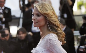 Model Model Heidi Klum poses for photographers as she arrives for the screening of Nebraska at the 66th international film festival, in Cannes, southern France, Thursday, May 23, 2013