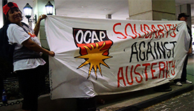 OCAP members hold Solidarity Against Austerity banner in Sheraton Hotel to protest shelter for the rich but not the poor.