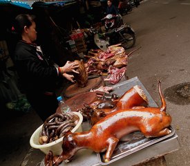 File - Dog meat for sale at a street stall in a market in Hanoi, Vietnam.