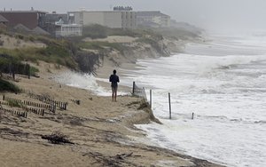 Heavy surf crashes the dunes at high tide in Nags Head, N.C., Thursday, Sept. 13, 2018 as Hurricane Florence approaches the east coast.