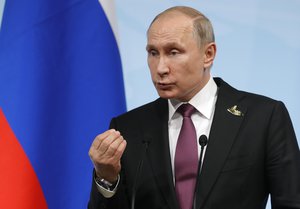 Russian President Vladimir Putin gestures during a press conference after the G-20 summit in Hamburg, northern Germany, Saturday, July 8, 2017