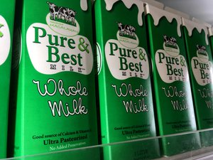 Whole Milk ultra pasteurized milk cartons in a market chiller. Taken on July 2017.