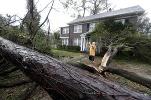 Mike Kiernan takes photos of the damage to his home in Wilmington, N.C., after Hurricane Florence made landfall Friday, Sept. 14, 2018.