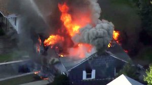 In this image take from video provided by WCVB in Boston, flames consume a home in Lawrence, Mass, a suburb of Boston, Thursday, Sept. 13, 2018.