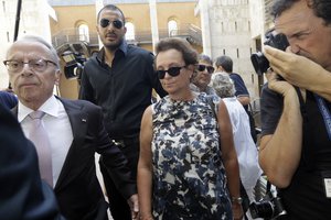 Sylvia Janowski, center, daughter of Helene Pastor, arrives at the court room in Aix-en-Provence, southern France, Monday, Sept.17, 2018. Helene Pastor, whose family built a real estate empire in Monaco with wealth rivaling that of the royal family, was shot with her chauffeur on May 6, 2014. Her son-in-law and nine others are going on trial over the murders.