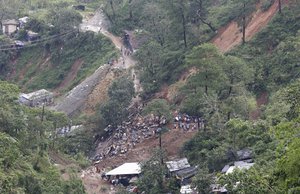 Rescuers dig on the site where victims were believed to have been buried by a landslide after Typhoon Mangkhut barreled across Itogon, Benguet province, northern Philippines on Monday, Sept. 17, 2018. Itogon Mayor Victorio Palangdan said that at the height of the typhoon’s onslaught Saturday afternoon, dozens of people, mostly miners and their families, rushed into an old three-story building in the village of Ucab. The building, a former mining bunkhouse that had been transformed into a chapel, was obliterated when part of a mountain slope collapsed. (AP Photo/Aaron Favila)