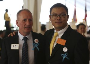 File - British cave expert Vernon Unsworth, left, poses with a guest during an event titled "United as One" in Bangkok, Thailand, Thursday, Sept. 6, 2018. It was showtime Thursday for the 12 boys and their 25-year old soccer coach, who shared their drama of being trapped for almost three weeks in a flooded cave in northern Thailand at a public exhibition in one of Bangkok's largest malls.