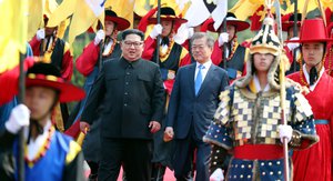 In this Friday, April 27, 2018, file photo, North Korean leader Kim Jong Un, left, and South Korean President Moon Jae-in, right, walk together through a honor guard at the border village of Panmunjom in the Demilitarized Zone.