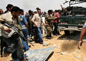  GAZA CITY, GAZA STRIP- May 16, 2007: Palestinians carry a wounded officer after an Israeli missile strike on a building in the Rafah refugee camp, in the southern Gaza Strip, in May 16, 2007. Israel has bombed a Hamas training camp in Gaza, killing two p