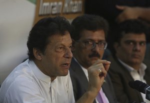 Pakistani opposition politician Imran Khan, left, chief of Pakistan Tehreek-e-Insaf party, speaks his supporters during an election campaign in Karachi, Pakistan, Wednesday, July 4, 2018.