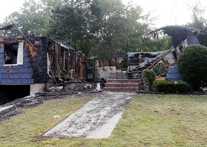 The house owned by Lawrence Police Officer Ivan Soto sits nearly burned to the ground on Jefferson Street, in Lawrence, Mass., Friday, Sept. 14, 2018. It was one of multiple houses that went up in flames on Thursday afternoon after gas explosions and fires