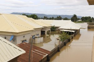 In this photo taken Friday, Sept. 14, 2018, houses are partially submerged on flooded streets after a heavy downpour in Koton Karfe, Nigeria.