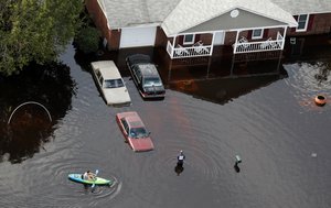 A man paddles a kayak in a flooded neighborhood, in the aftermath of Hurricane Florence, in Fayetteville, N.C., Monday, Sept. 17, 2018.