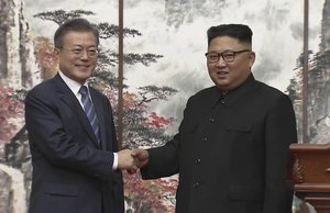 In this image made from video provided by Korea Broadcasting System (KBS), North Korean leader Kim Jong Un, right, and South Korean President Moon Jae-in shake hands at the end of their joint press conference in Pyongyang, North Korea Wednesday, Sept. 19, 2018.