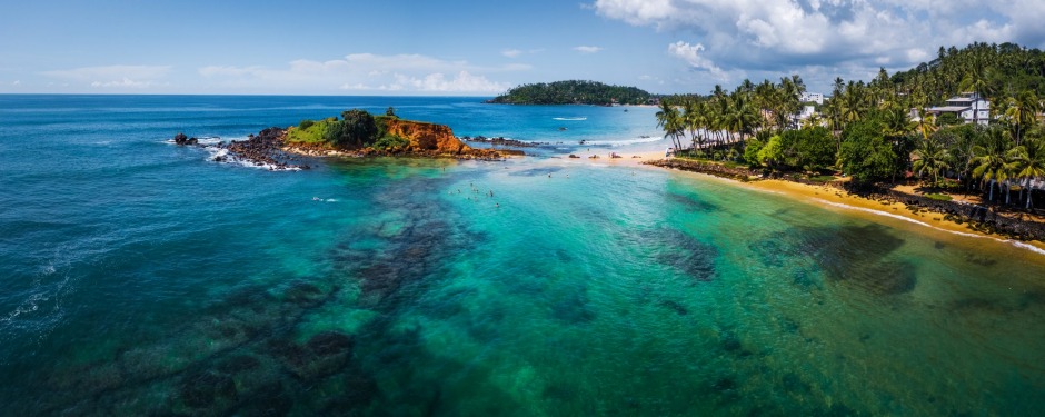 The beach and coral reef at the Sri Lankan seaside town of Mirissa.