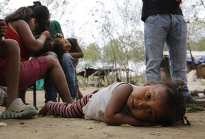 In this June 26, 2018 photo, a Venezuelan Yupka girl eyes the camera at a camp set up in Cucuta, Colombia, near the border with Venezuela.