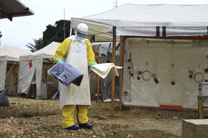 In this photo taken Sunday, Sept 9, 2018, a health worker in protective gear works at an Ebola treatment centre in Beni, Eastern Congo.