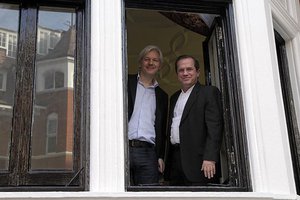 File - Julian Assange with Ricardo Patino, Minister of Foreign Affairs of Ecuador, look out the window of the Ecuadorian Embassy, London,16 June, 2013.