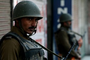 Indian paramilitary troops  stand guard near closed shops during a strike in Srinagar October 27, 2009. Shops and businesses closed on Tuesday in Indian Kashmir's main city in response to a strike called by separatists, a day before a planned visit by Indian Prime Minister Manmohan Singh.The strike, called by hardline separatist leader Syed AliShah Geelani, marks the 62nd anniversary of New Delhi's rule over the troubled region.