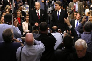 In this Sept. 4, 2018, file photo Supreme Court nominee Judge Brett Kavanaugh is surrounded by photographers as he stands with Senate Judiciary Committee Chairman Chuck Grassley R-Iowa, during his confirmation hearing on Capitol Hill in Washington.