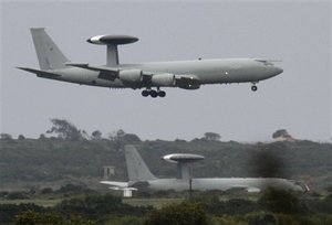 A British RAF AWAC plane prepares to land as another one is seen on the ground at the RAF (Royal Air Force) Akrotiri, a British military base, near southern port city of Limassol, Cyprus, Sunday, March 20, 2011. In diplomatic terms, international military action against Libya's leader went from the brainstorming stage to the shooting-at-tanks stage with stunning speed. Saturday's launch of military strikes by French, British and U.S. forces with Arab backing and U.N. mandate was not universally endorsed. And it's unclear whether it will be fast enough to do what its proponents want, to shore up rebel forces and oust Libya's leader Moammar Gadhafi.