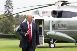 File - President Donald J. Trump walks across the South Lawn of the White House Sunday, March 25, 2018, returning home from his trip to New York