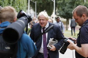 British MP Boris Johnson walks near Whitehall in central London, Tuesday, Aug. 14, 2018 after roads were blocked when a car has crashed into barriers outside the Houses of Parliament.